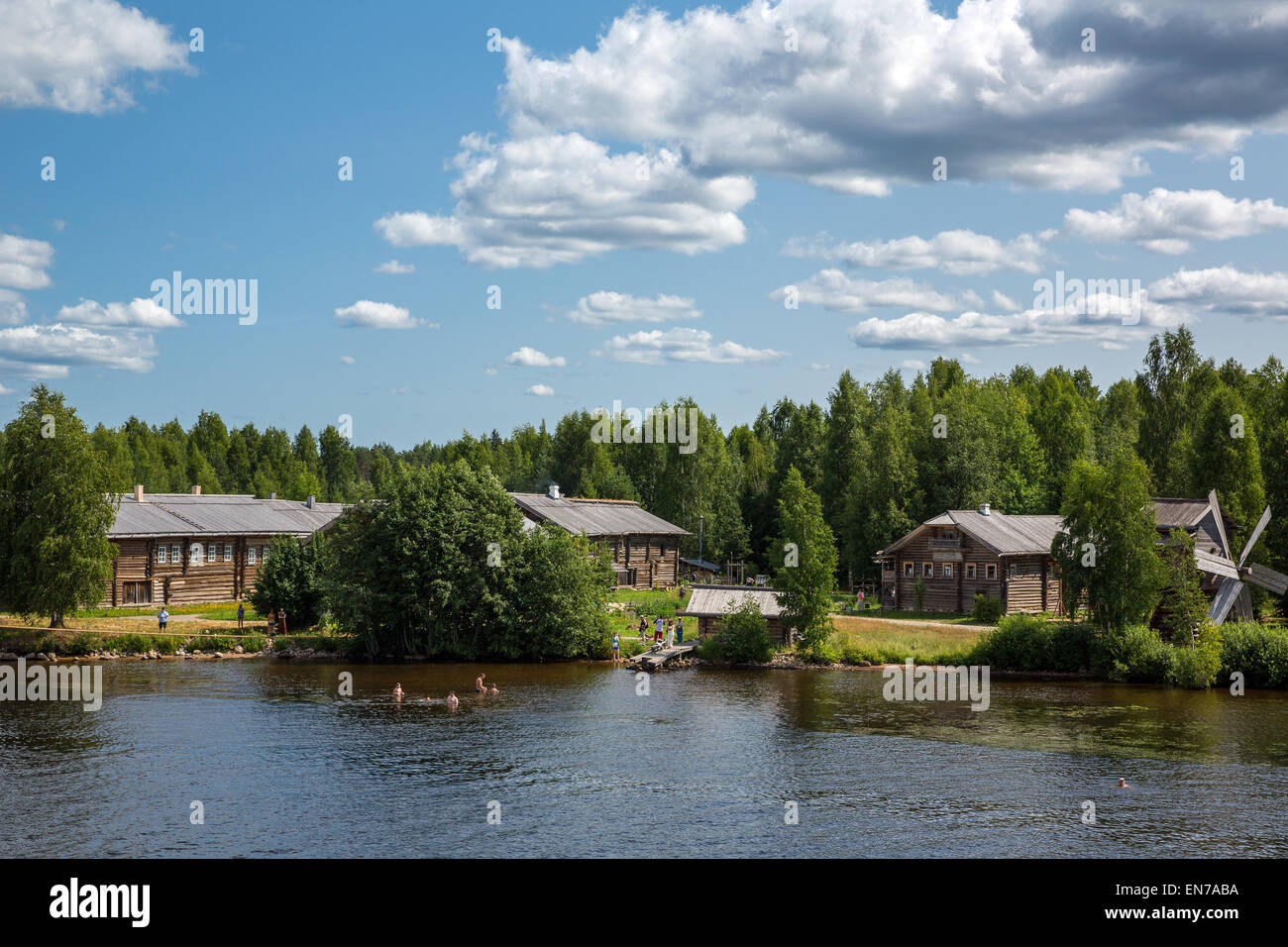 Russia, Leningrad region, Mandrogi, a craft village on the Svir river bank, old wooden houses and local people taking bath Stock Photo