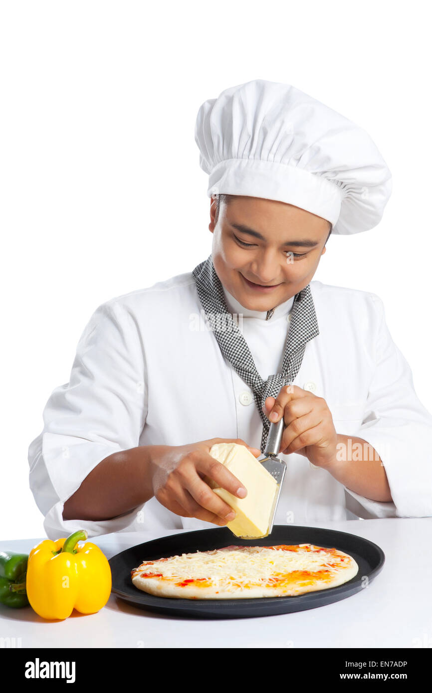 Chef grating cheese on pizza Stock Photo