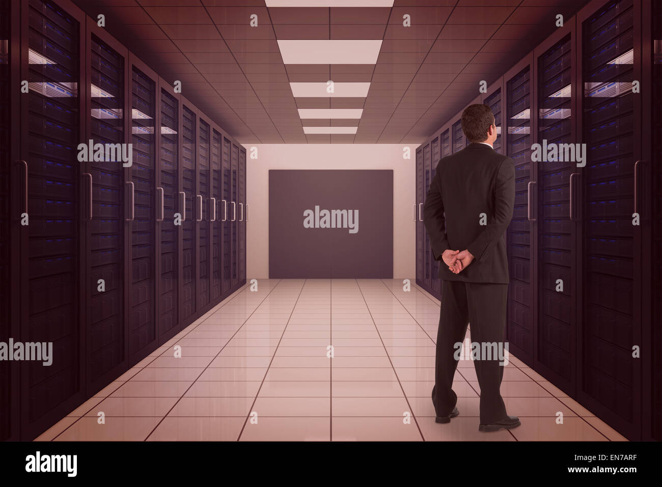 Composite image of businessman standing and looking Stock Photo
