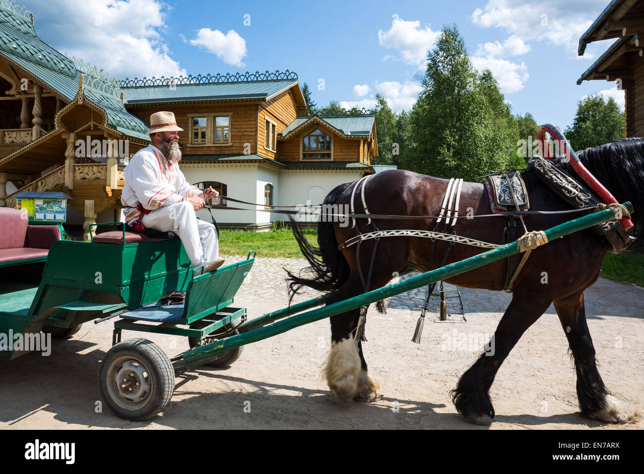 Russia, Leningrad region, Mandrogi, a craft village on the Svir river bank, a bearded man in traditional dress on a carriage for Stock Photo