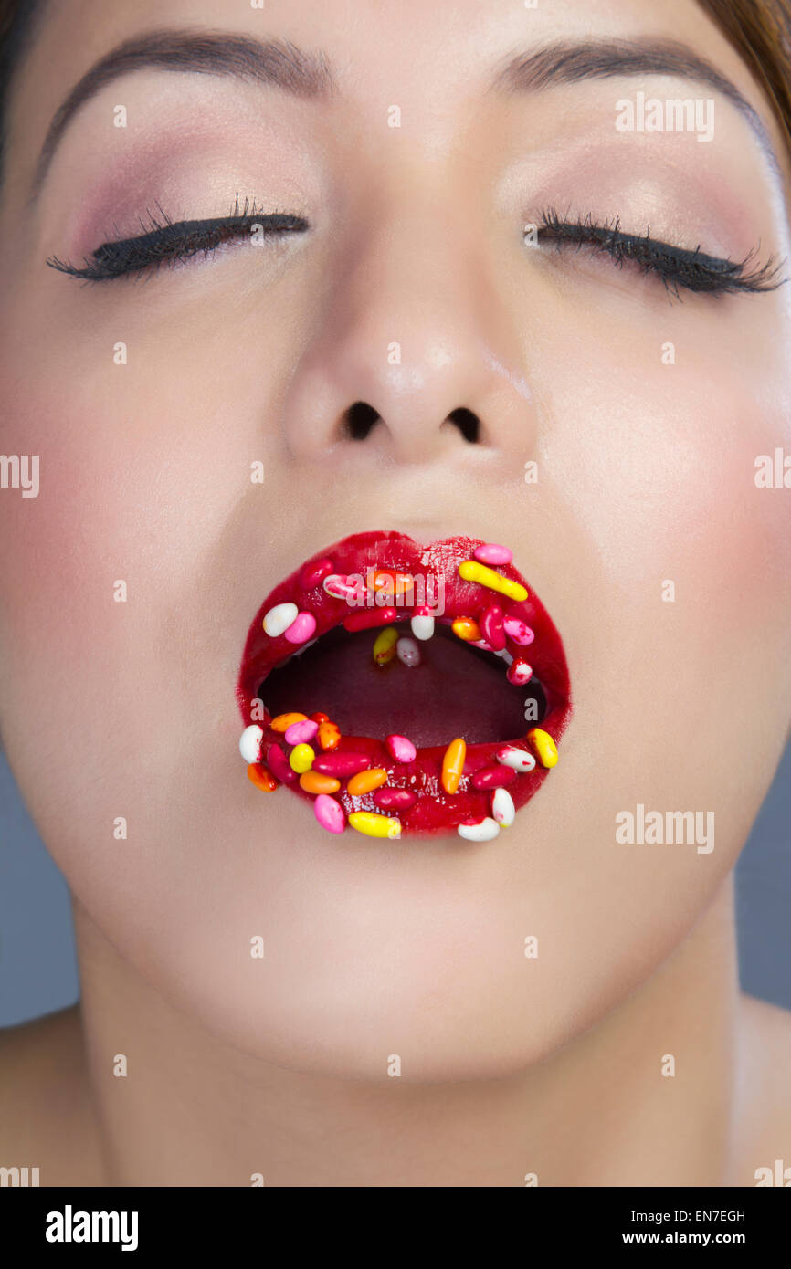 Woman with colourful candy on lips Stock Photo Alamy