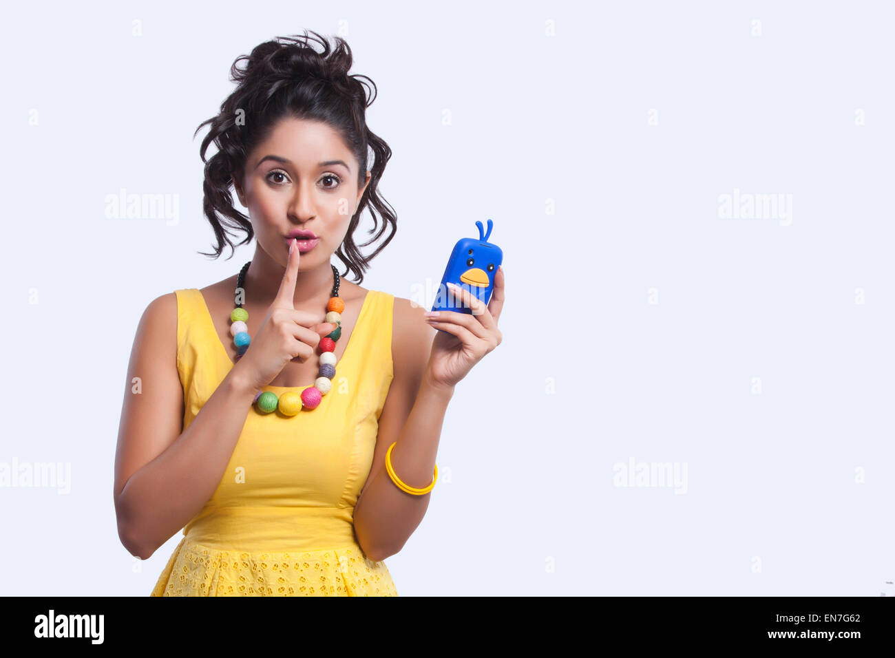 Portrait of woman with finger on lips Stock Photo - Alamy