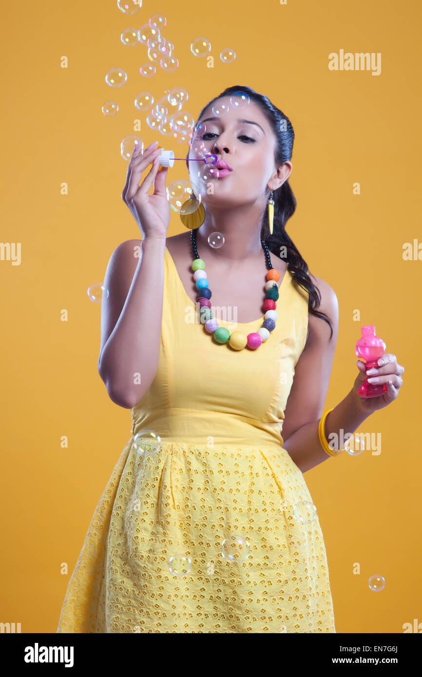 Young woman blowing bubbles Stock Photo - Alamy