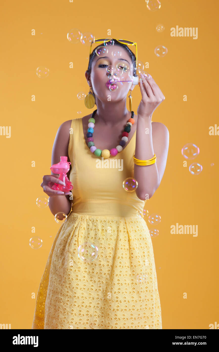 Young woman blowing bubbles Stock Photo - Alamy