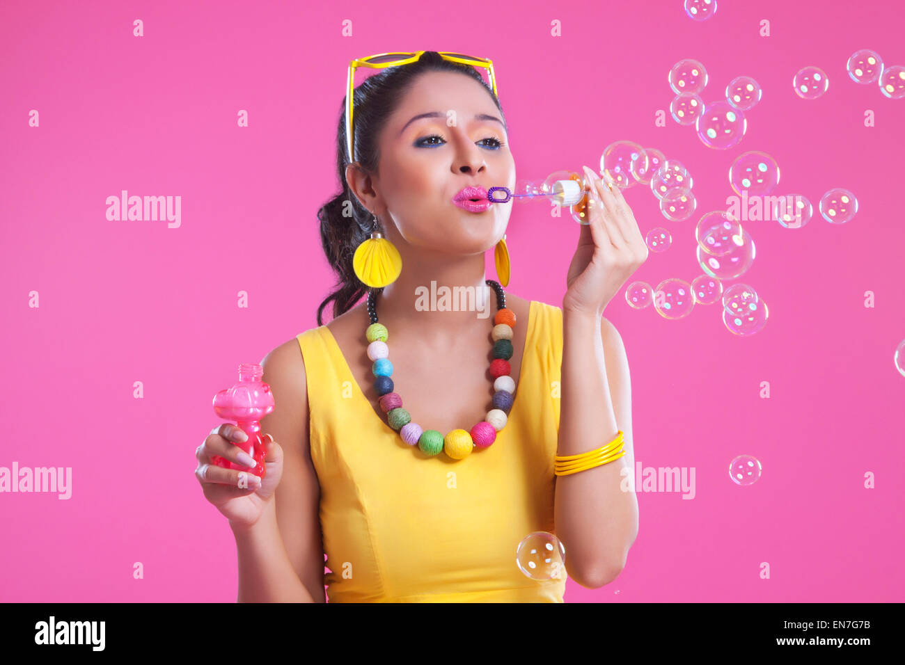 Young woman blowing bubbles Stock Photo - Alamy
