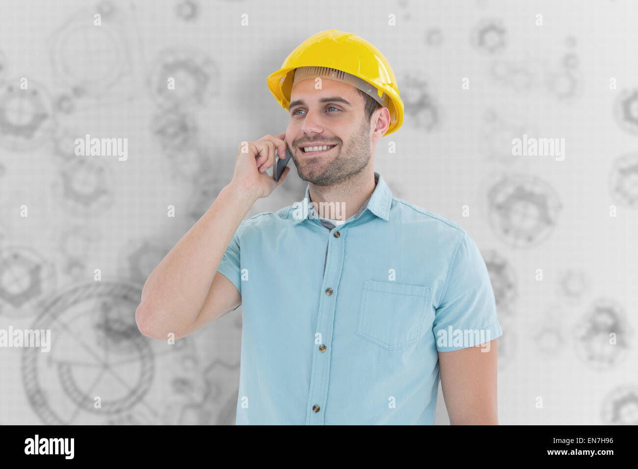 Composite image of happy male architect conversing on mobile phone Stock Photo