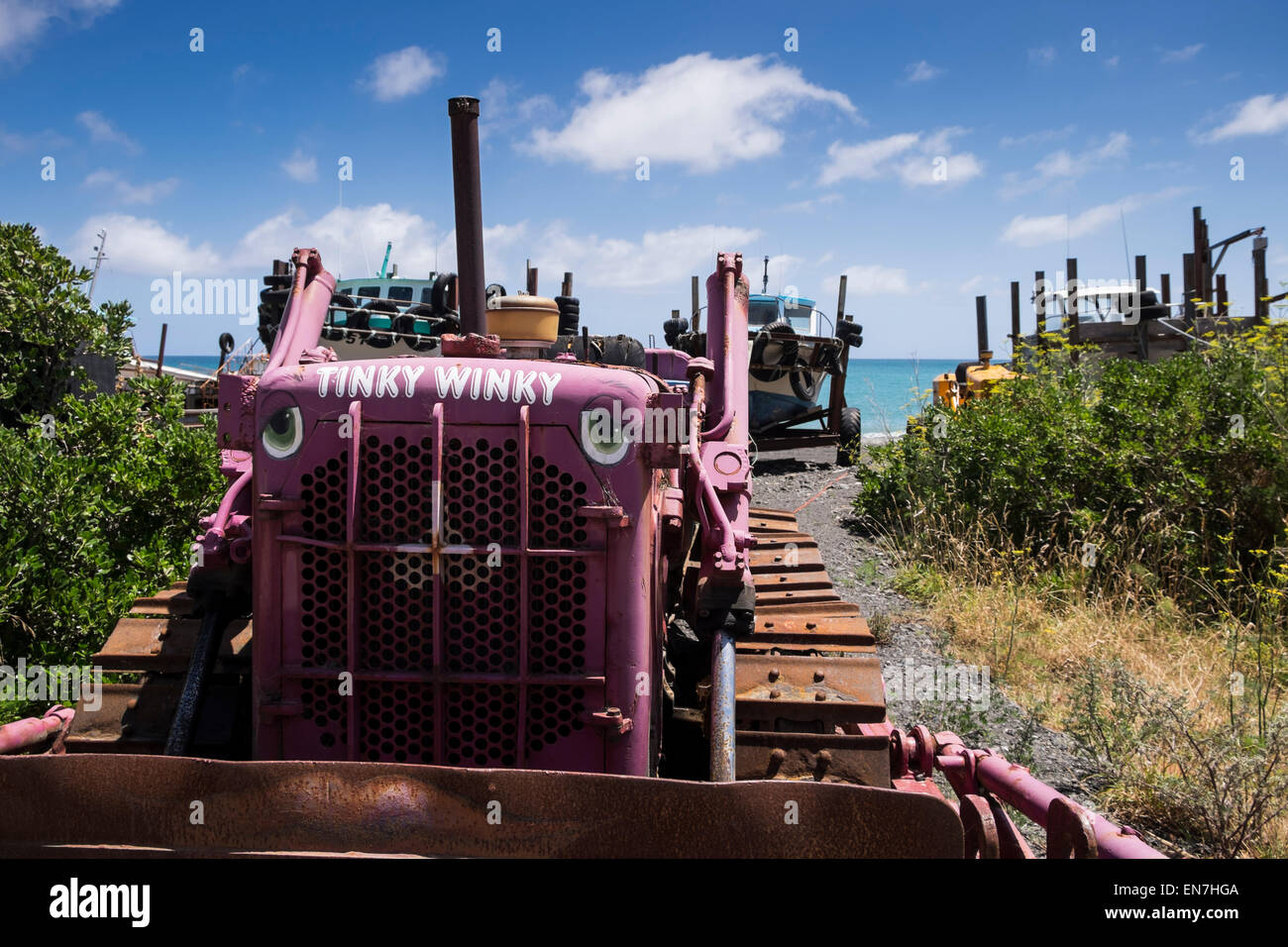 Bulldozers at the beach in the fishing village of Ngawi, used to launch boats, New Zealand. Stock Photo