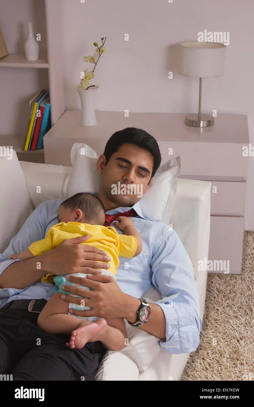 Father and baby sleeping on sofa Stock Photo Alamy