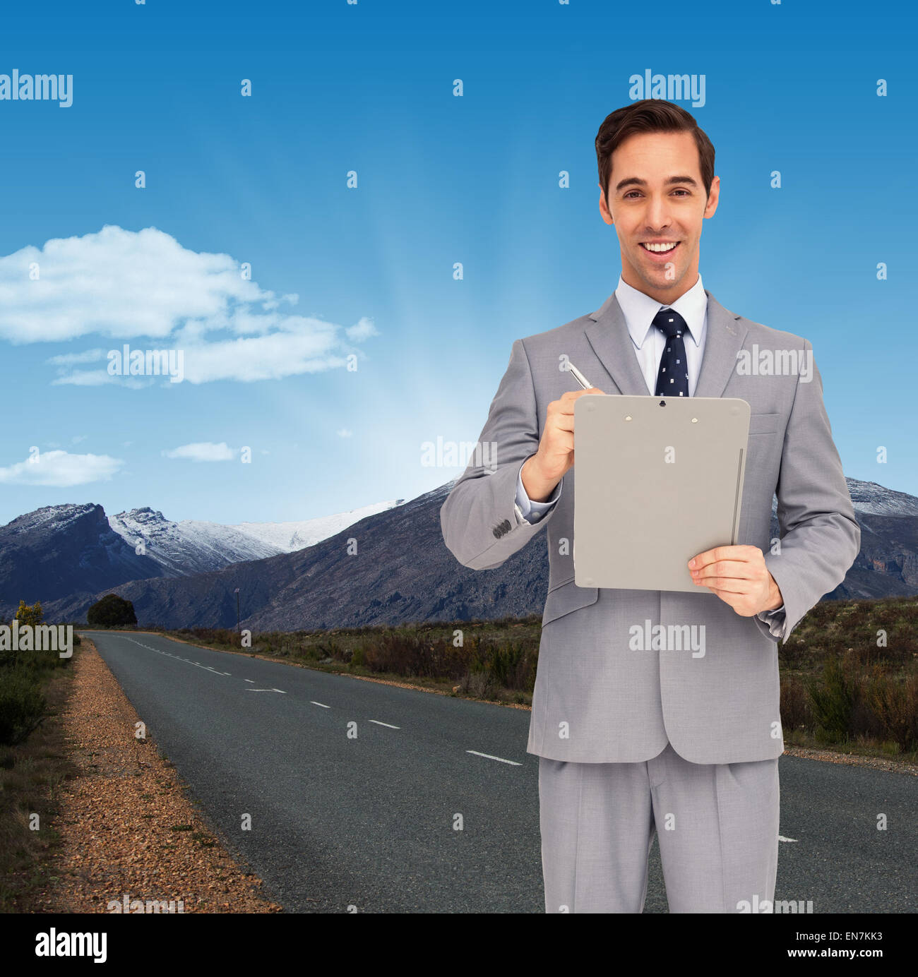 Composite image of happy businessman holding a clipboard Stock Photo ...
