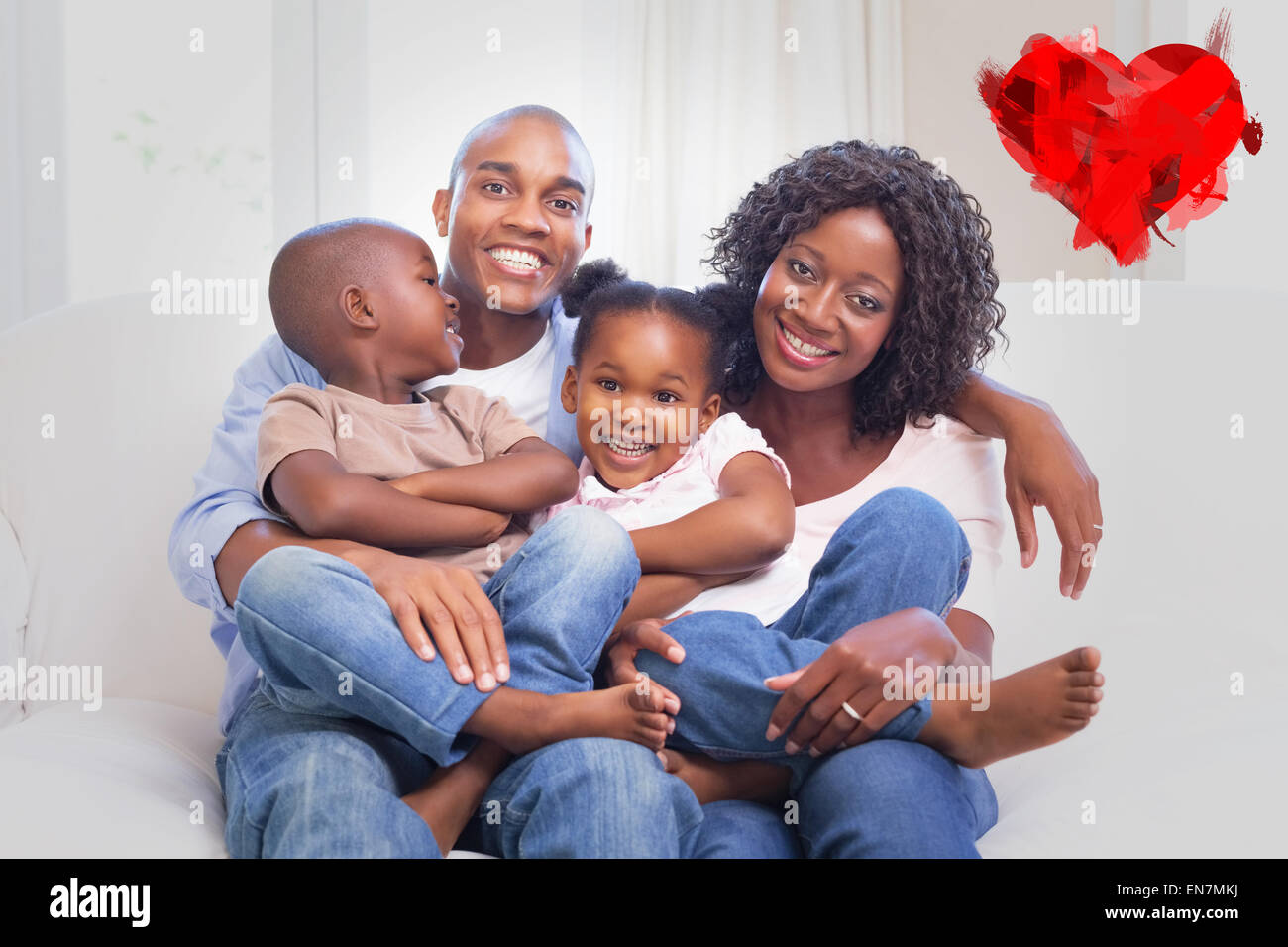 Composite image of happy family posing on the couch together Stock Photo