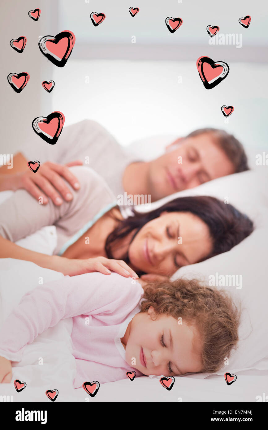 Composite image of family sleeping on the bed Stock Photo