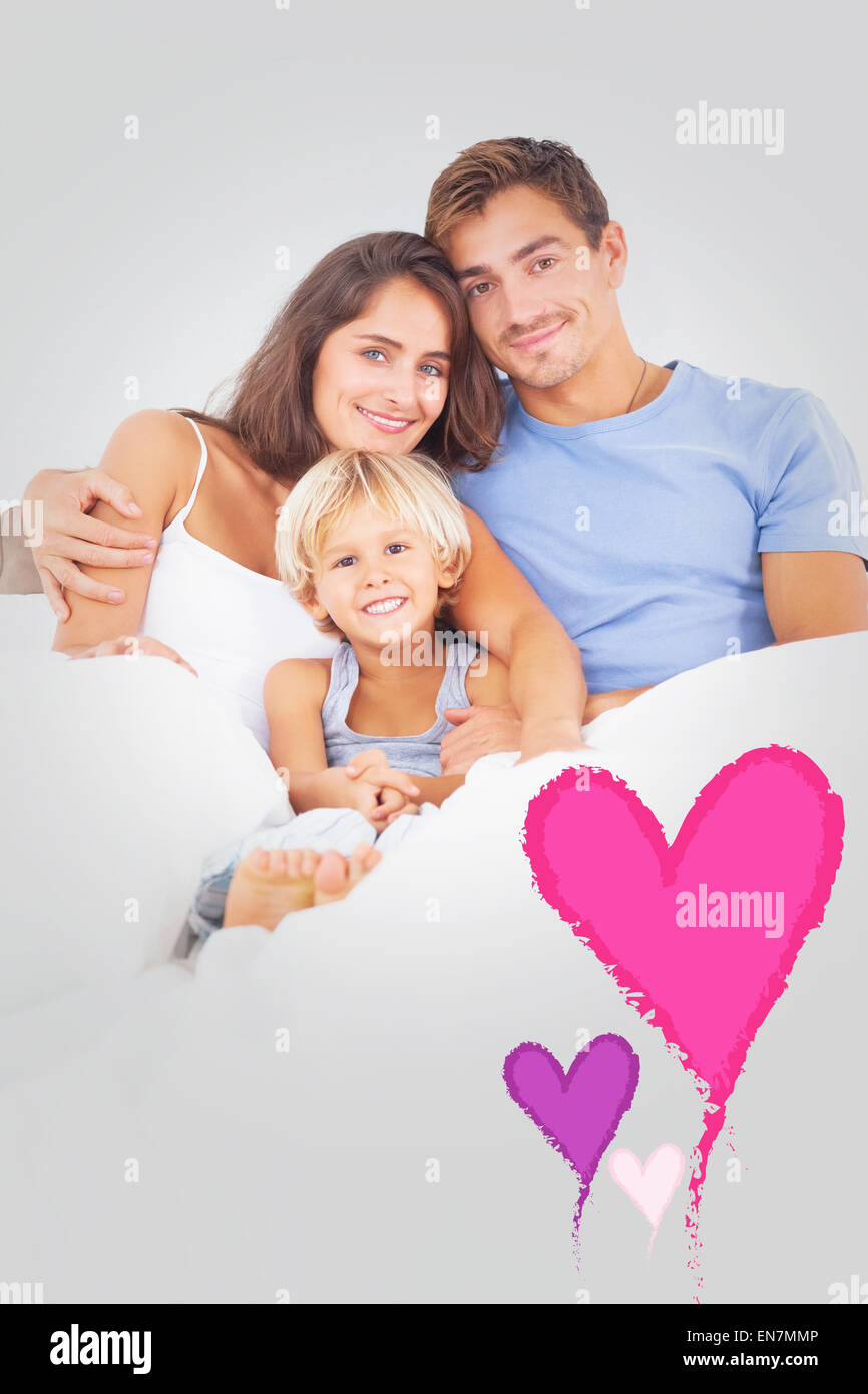 Composite image of lovely family embracing Stock Photo