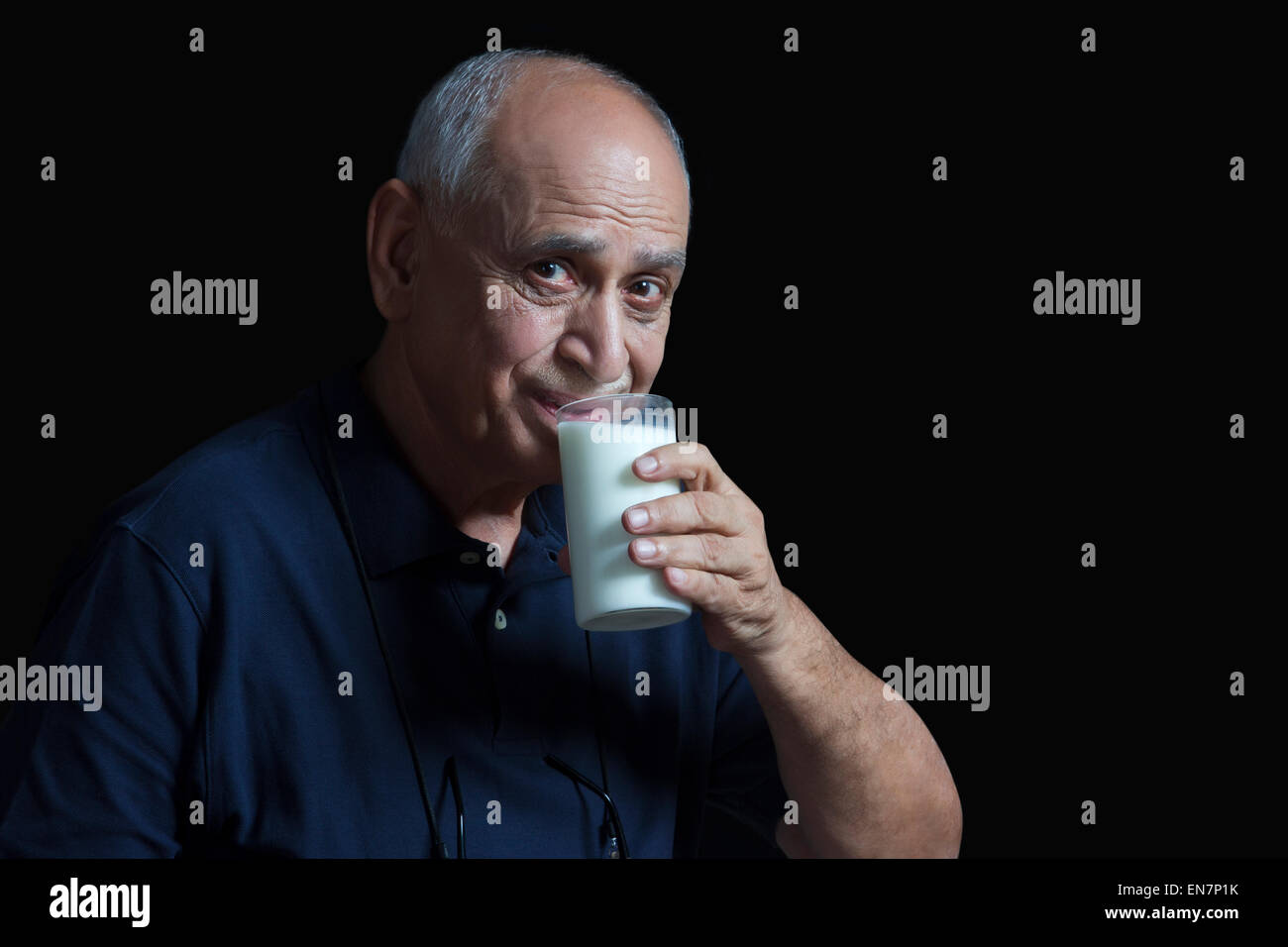 Old man drinking glass of milk Stock Photo - Alamy