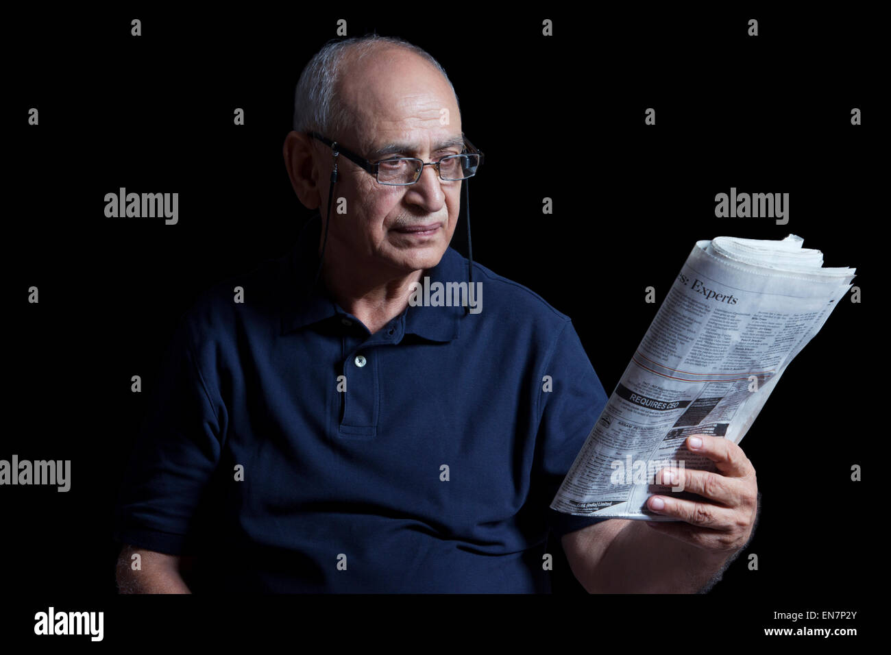 Old man reading newspaper Stock Photo