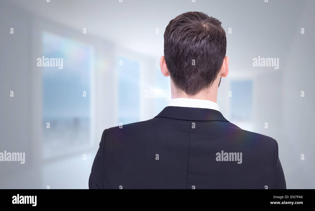 Composite image of rear view of businessman in suit standing Stock ...