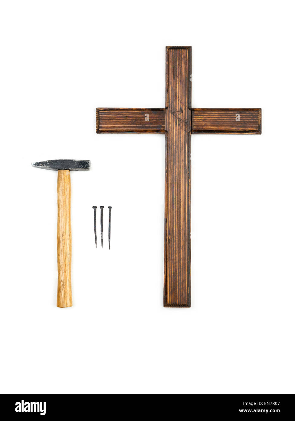 Wooden empty cross, hammer and three nails - do-it-yourself crucifying concept Stock Photo