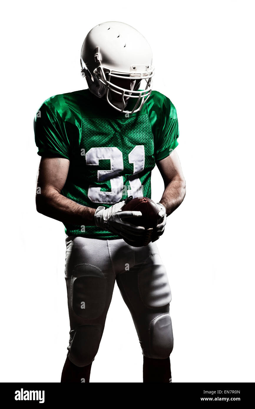 Football Player with a green uniform and a ball in the hand on a white