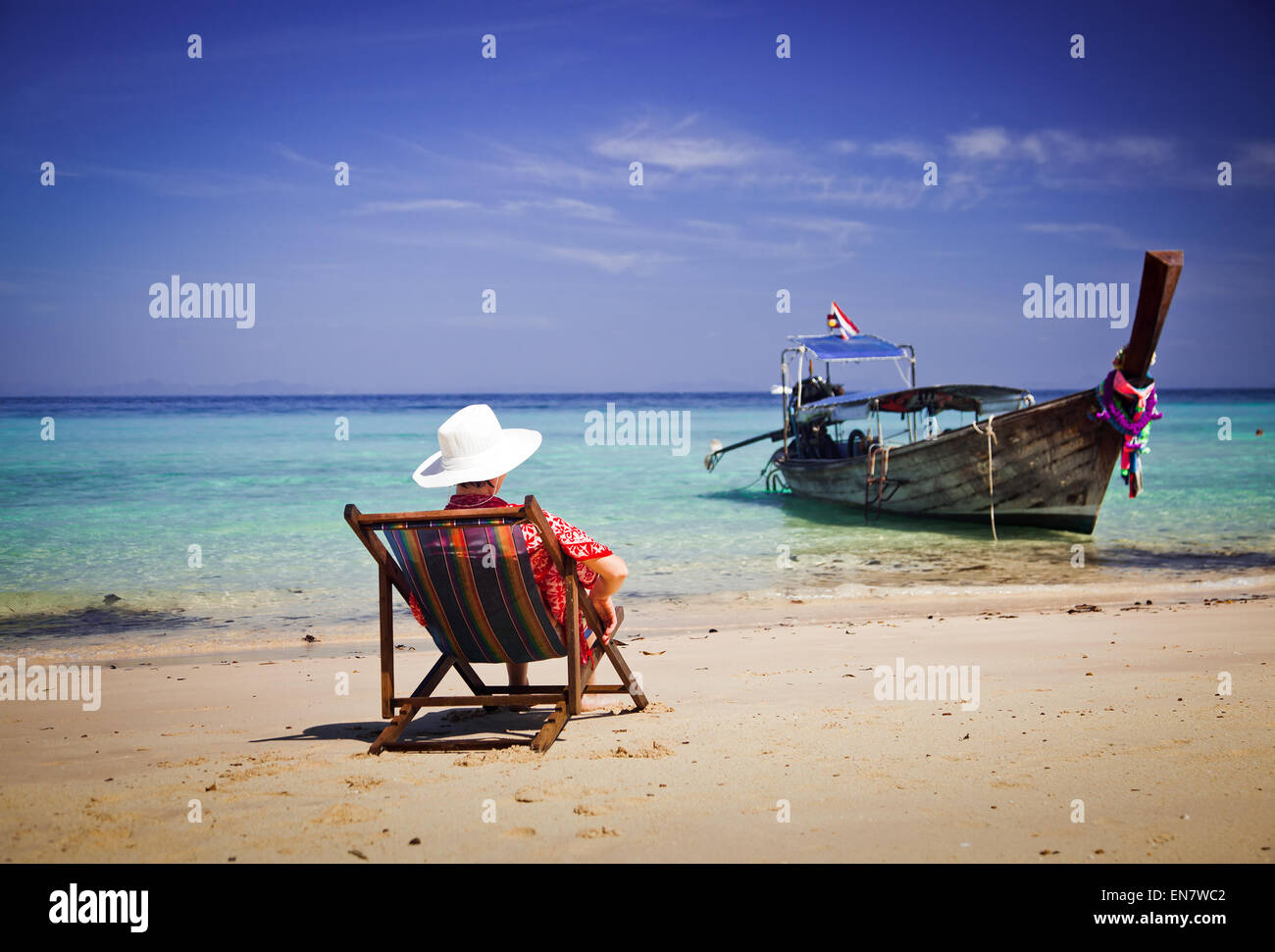 Exotic beach holiday background with beach chair and long tail boat - Thailand ocean landscape Stock Photo