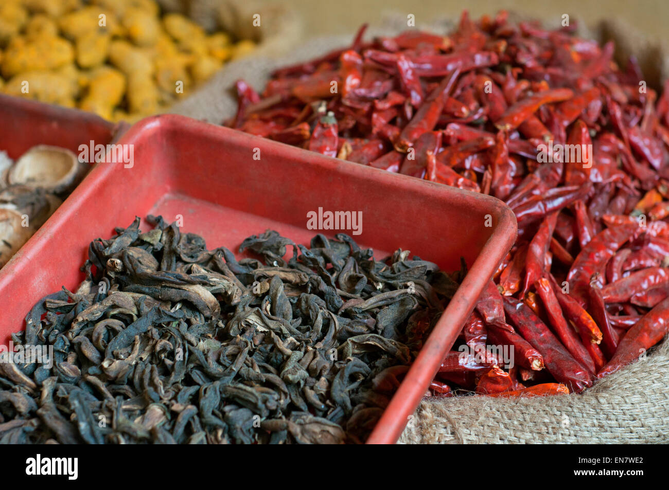 Sacks of dried chillies and dried mango for sale at the market Stock