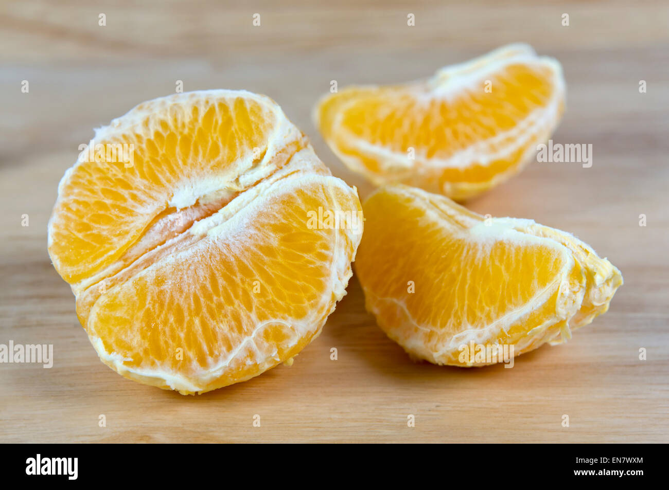 Half peeled orange on chopping board Stock Photo - Alamy