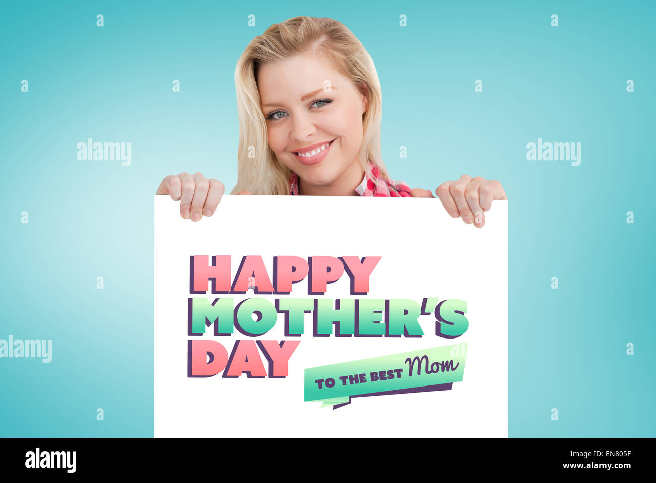 Composite image of woman beaming while holding a blank sign Stock Photo