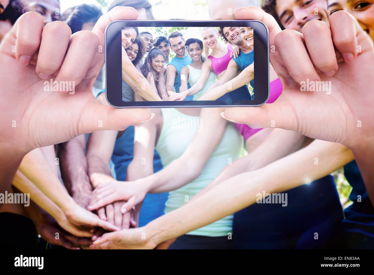 Composite image of hand holding smartphone showing Stock Photo