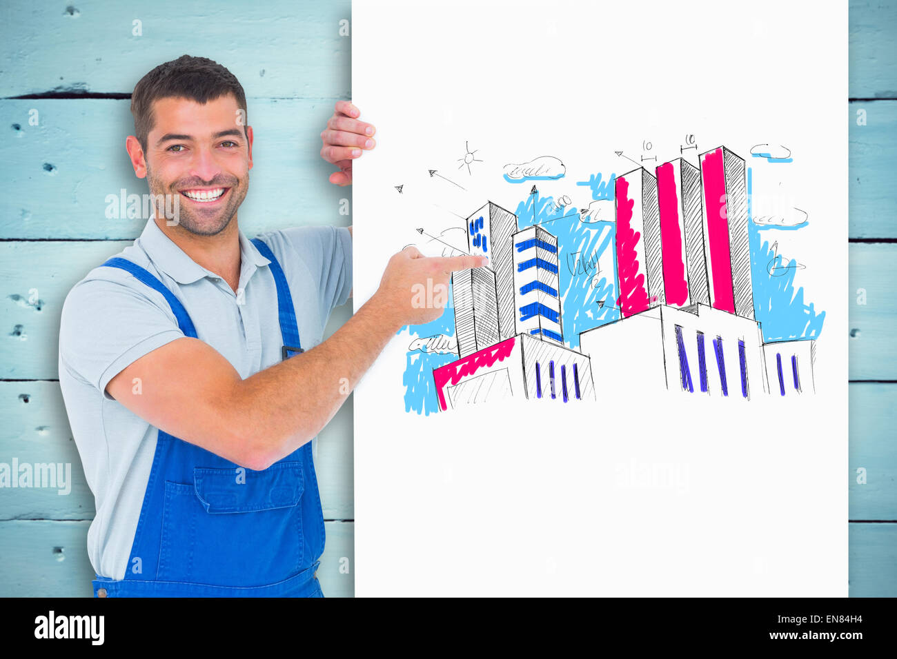 Composite image of repairman in overalls pointing at placard Stock Photo