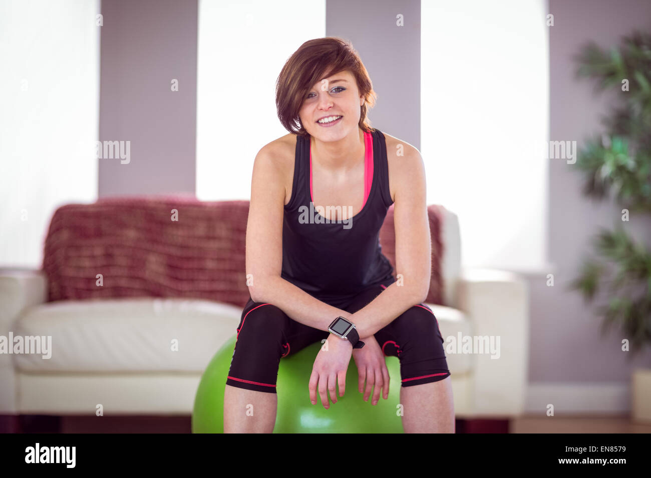 Fit woman sitting on exercise ball Stock Photo - Alamy
