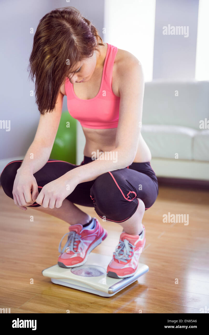 Woman standing on scales Stock Photo Alamy