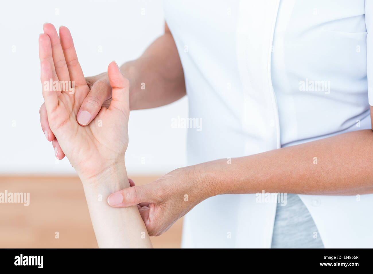 Physiotherapist examining her patients hand Stock Photo