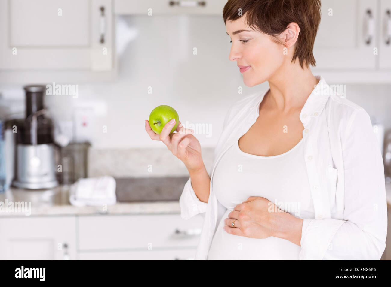 Pregnant woman eating an apple Stock Photo Alamy