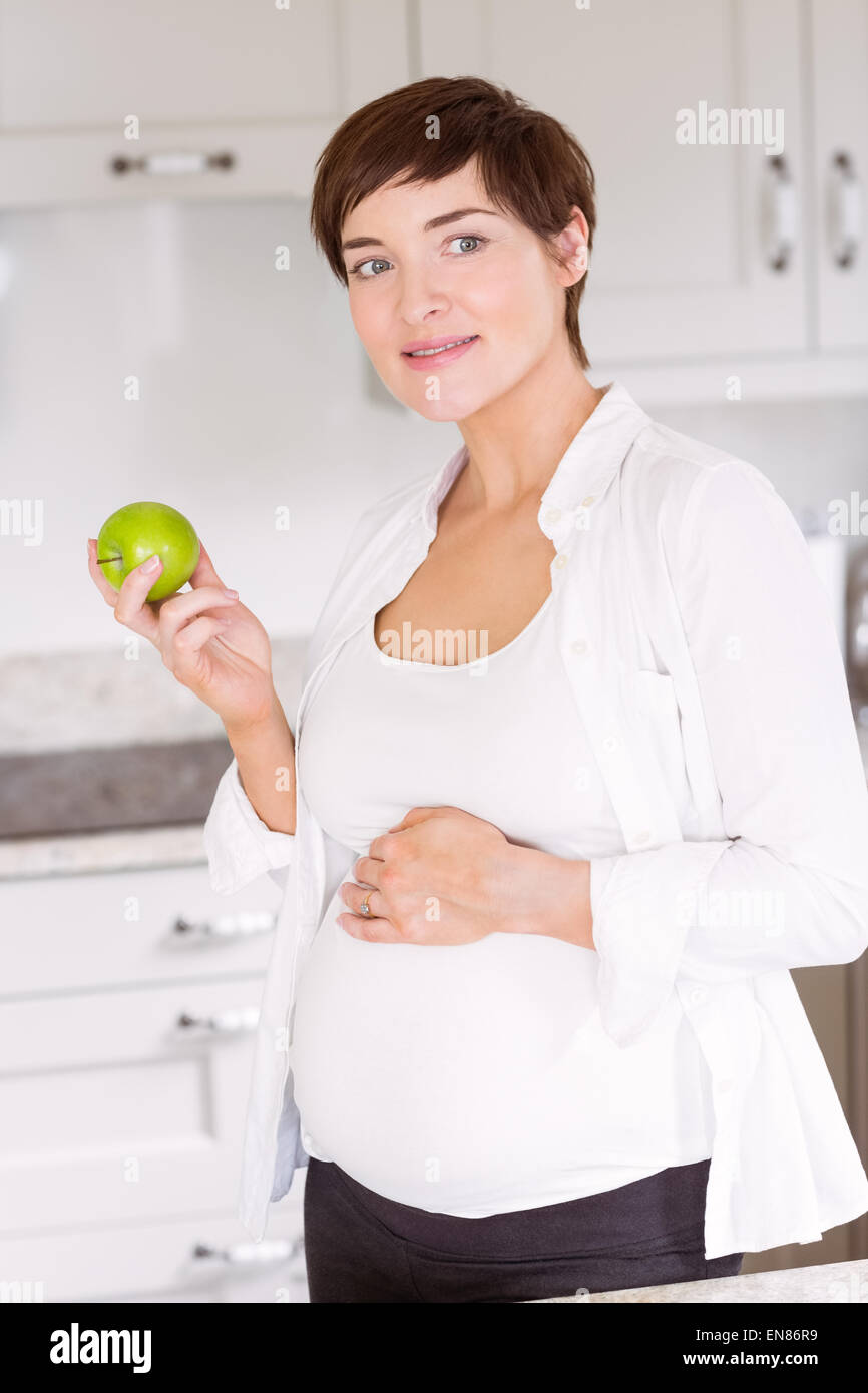 Pregnant woman eating an apple Stock Photo Alamy