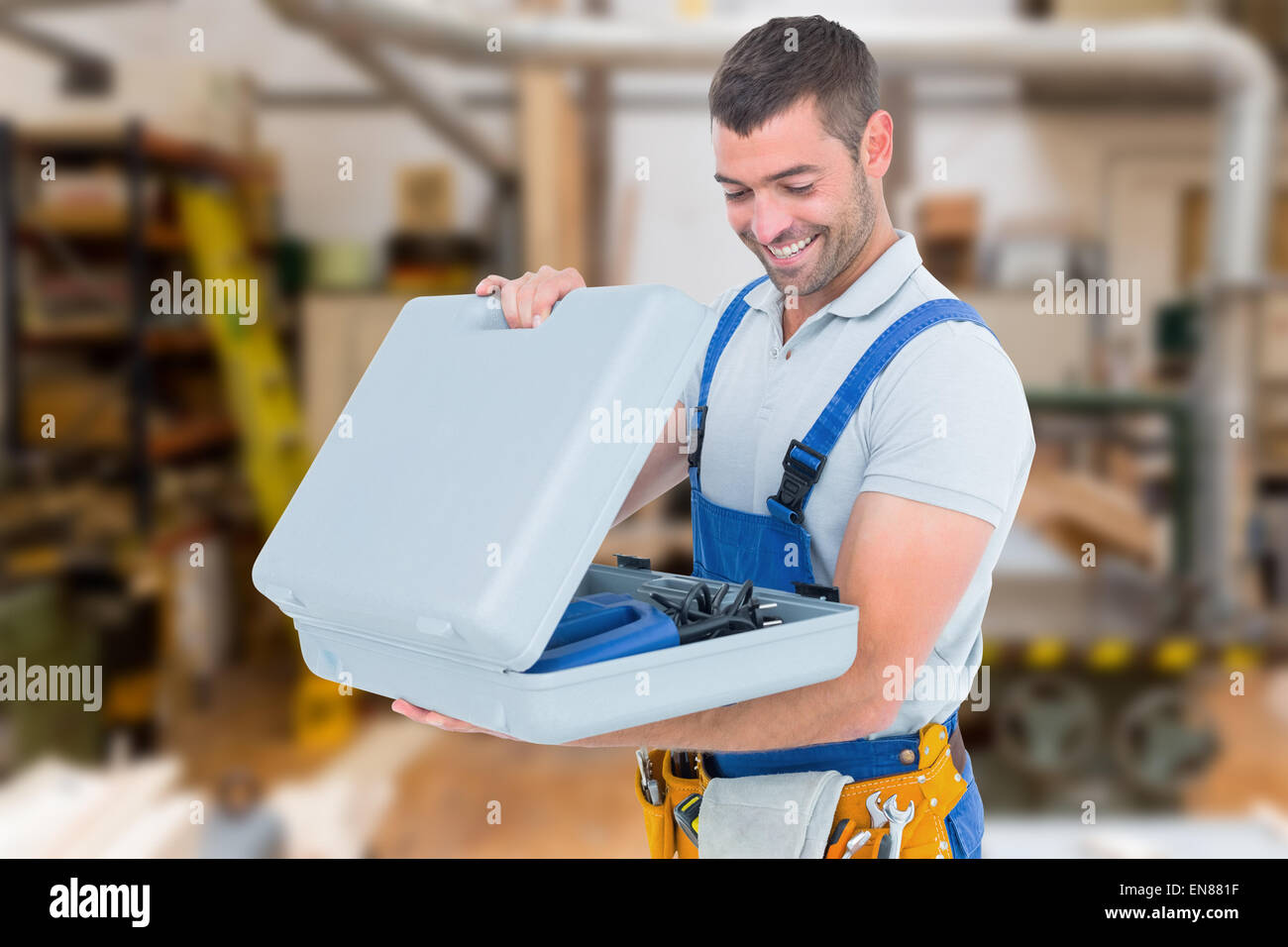 Composite image of happy repairman opening toolbox Stock Photo