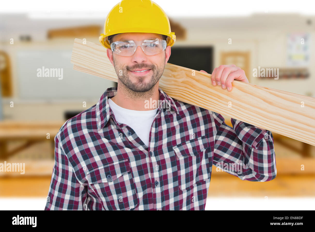 Composite image of handyman holding wood planks Stock Photo