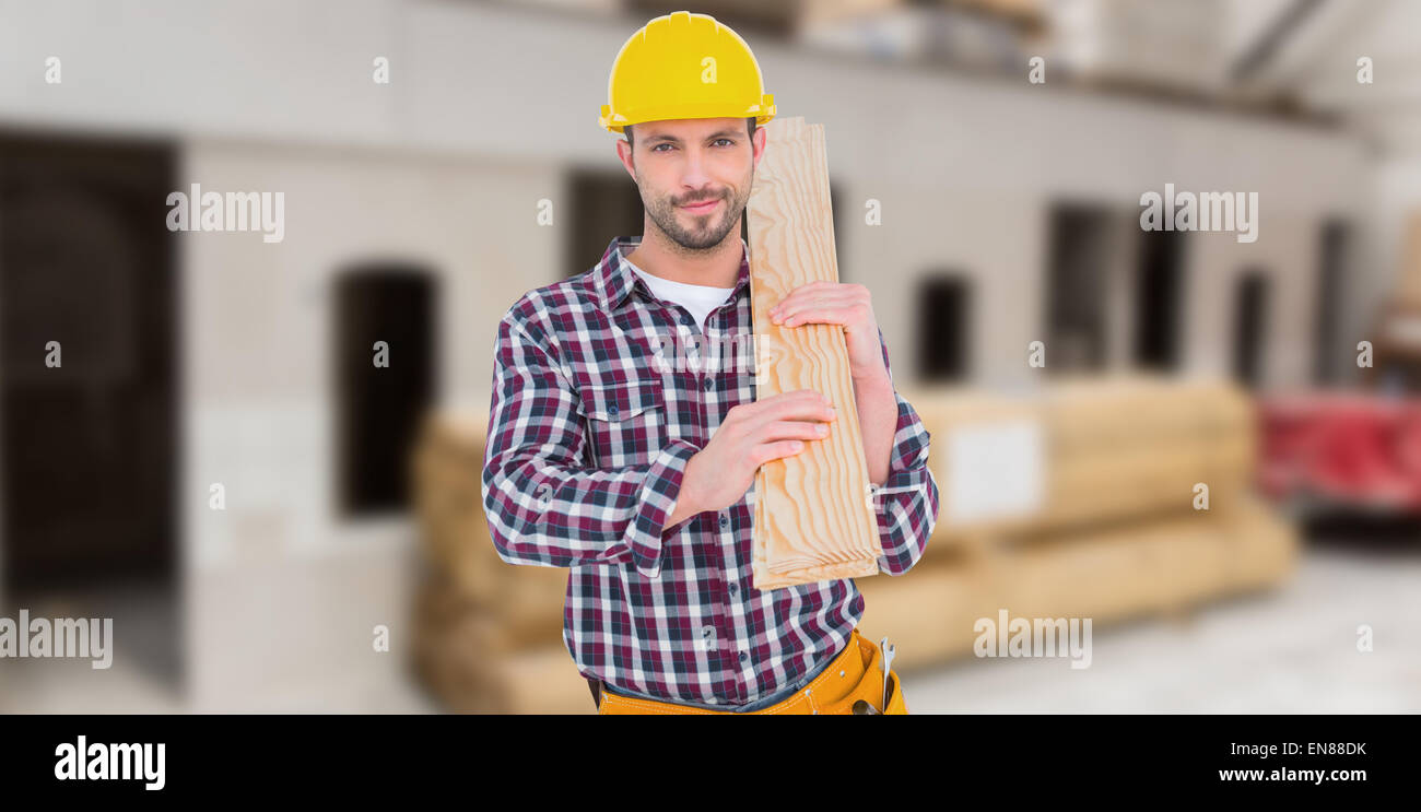 Composite image of handyman holding wood planks Stock Photo
