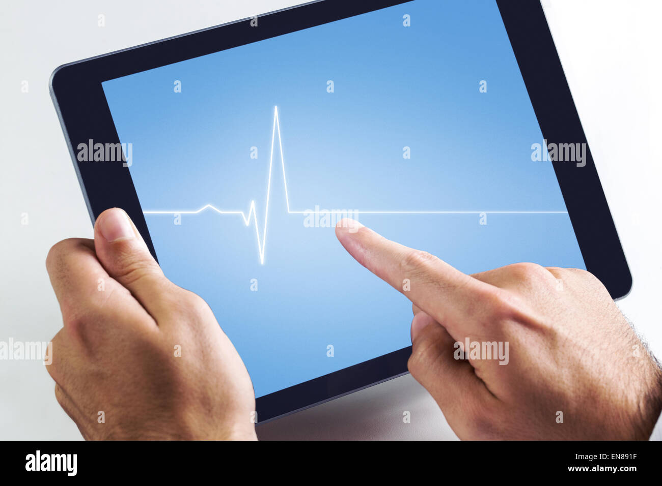 Composite image of man using tablet pc Stock Photo