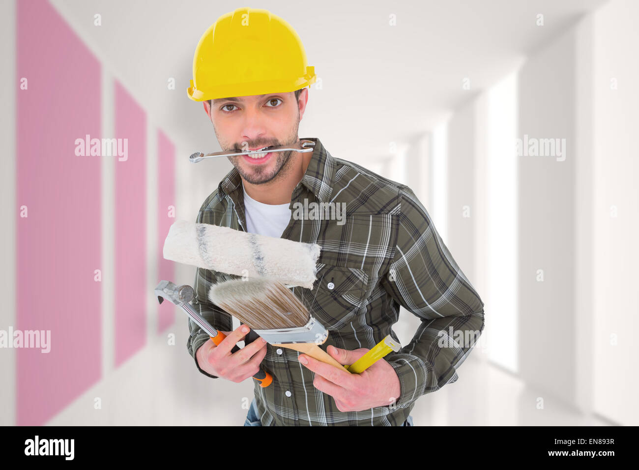 Composite image of manual worker holding various tools Stock Photo