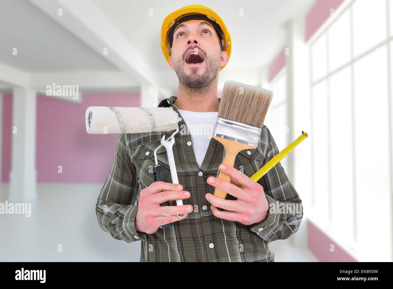 Composite image of screaming manual worker holding various tools Stock Photo