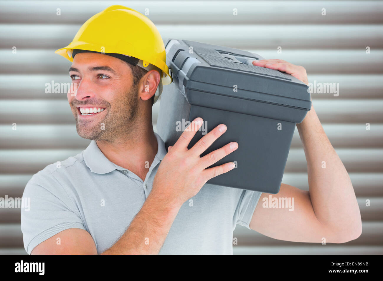 Composite image of handyman carrying toolbox on shoulder Stock Photo