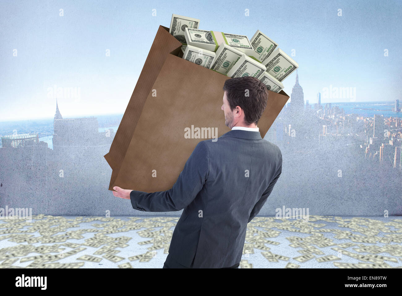 Composite image of businessman carrying bag of dollars Stock Photo