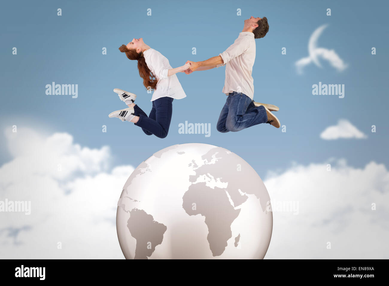 Composite image of couple jumping and holding hands Stock Photo