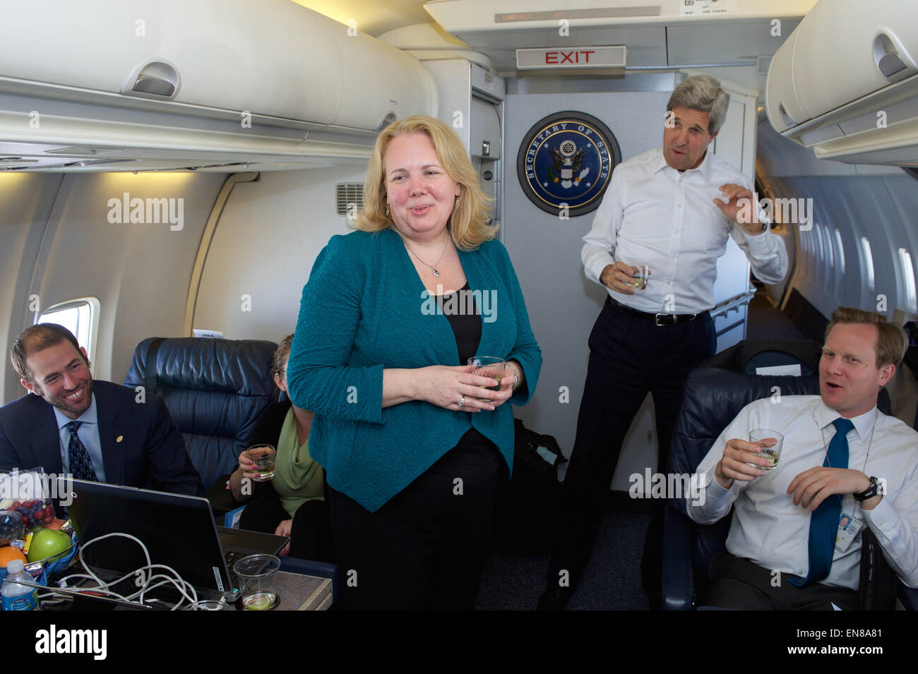 U.S. Secretary of State John Kerry leads his staff in an airborne rendition of &quot;Happy Birthday&quot; on April 15, 2015, as they celebrate the birthday of and final trip for State Department Executive Director Kathleen Hill, a career Foreign Service Officer departing to a new assignment after organizing Secretary's visit to Lubeck, Germany, and his 59 preceding international trips across 765,000 miles since he assumed office in February 2013. Stock Photo