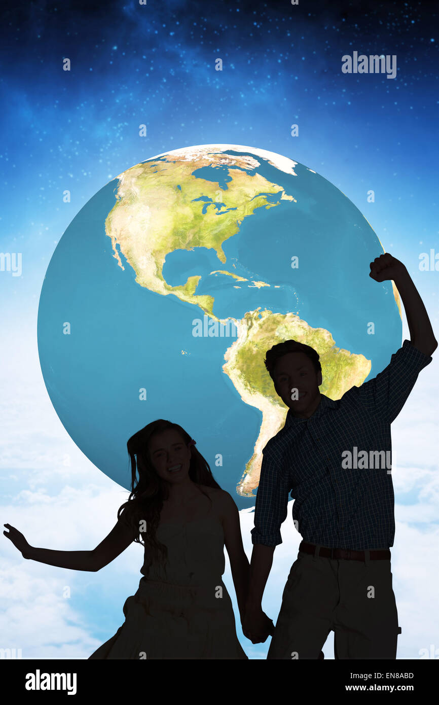 Composite image of cheerful young couple jumping Stock Photo