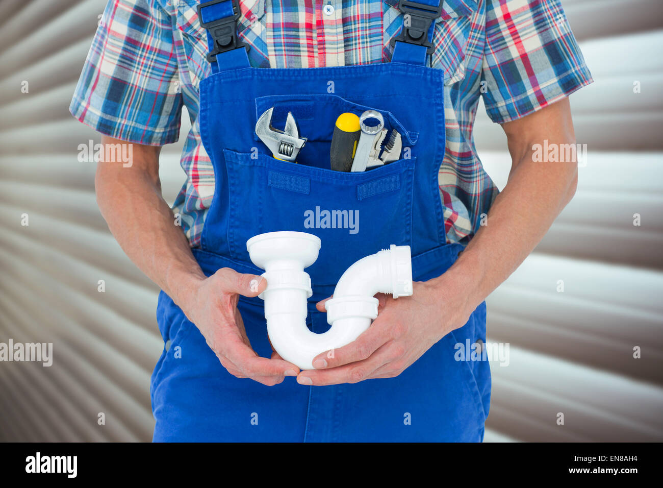 Composite image of cropped image of plumber holding sink pipe Stock Photo