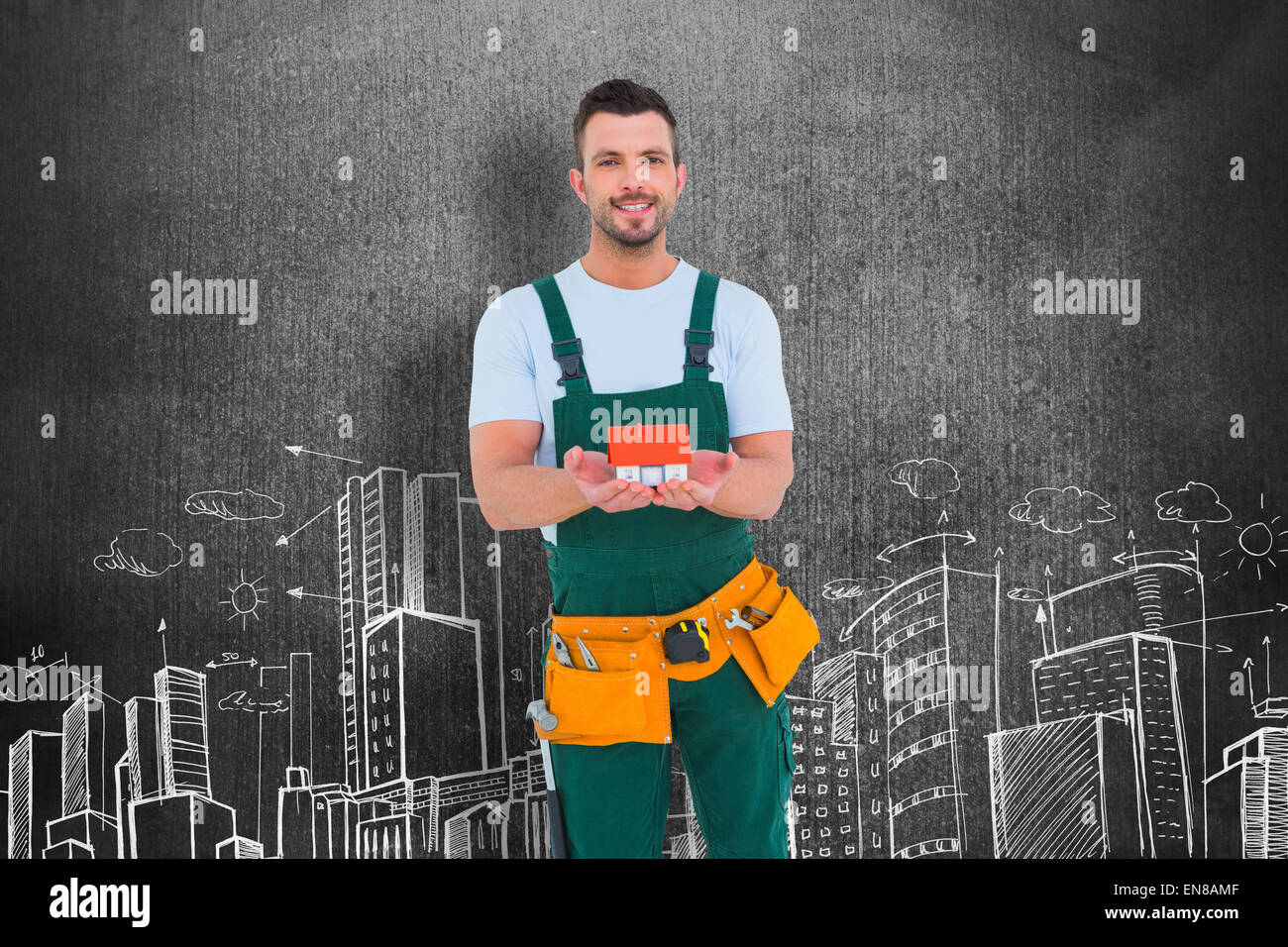 Composite image of happy construction worker holding house model Stock Photo