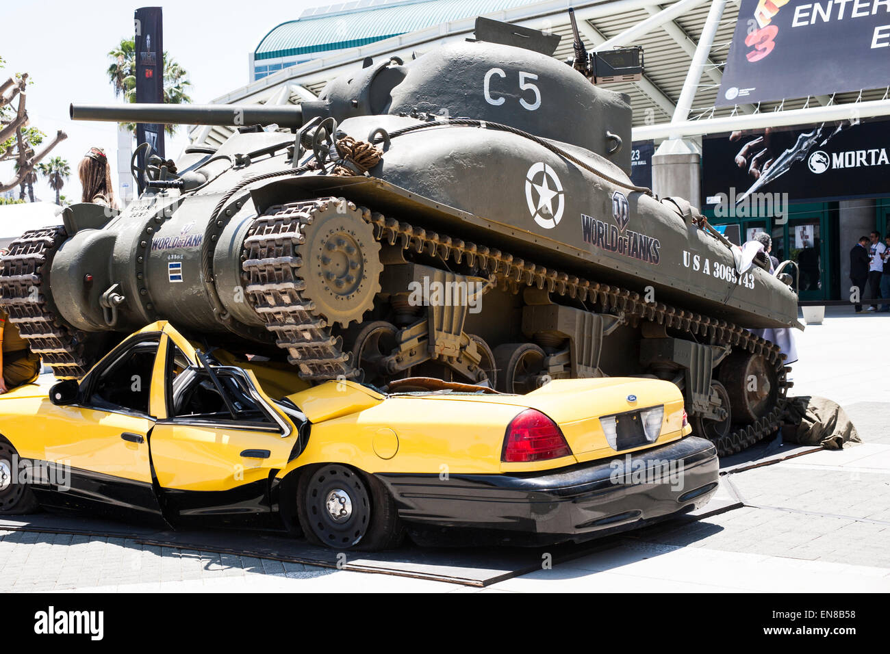 A full size replica of a World War 2 tank as featured in the video game crushing a taxi cab in front of the 2014 E3 Expo. Stock Photo