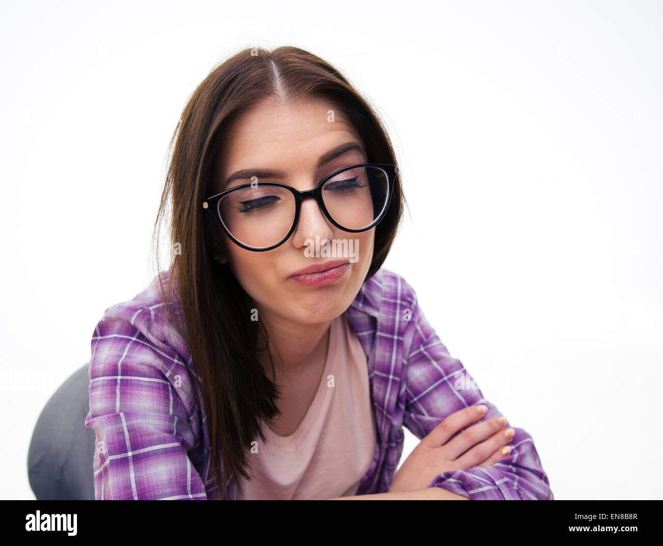 Young woman in glasses making funny face over white background Stock Photo