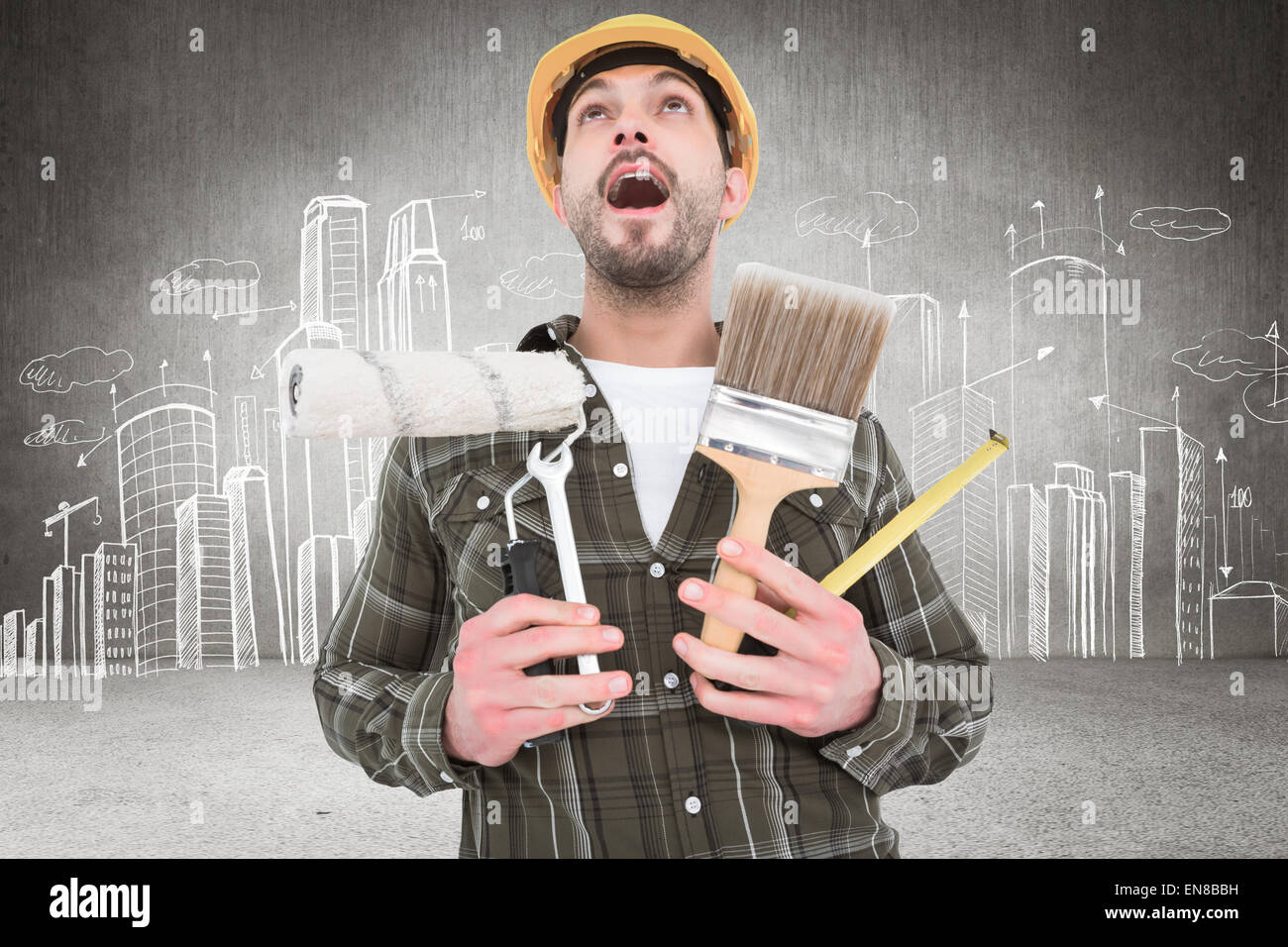 Composite image of screaming manual worker holding various tools Stock Photo