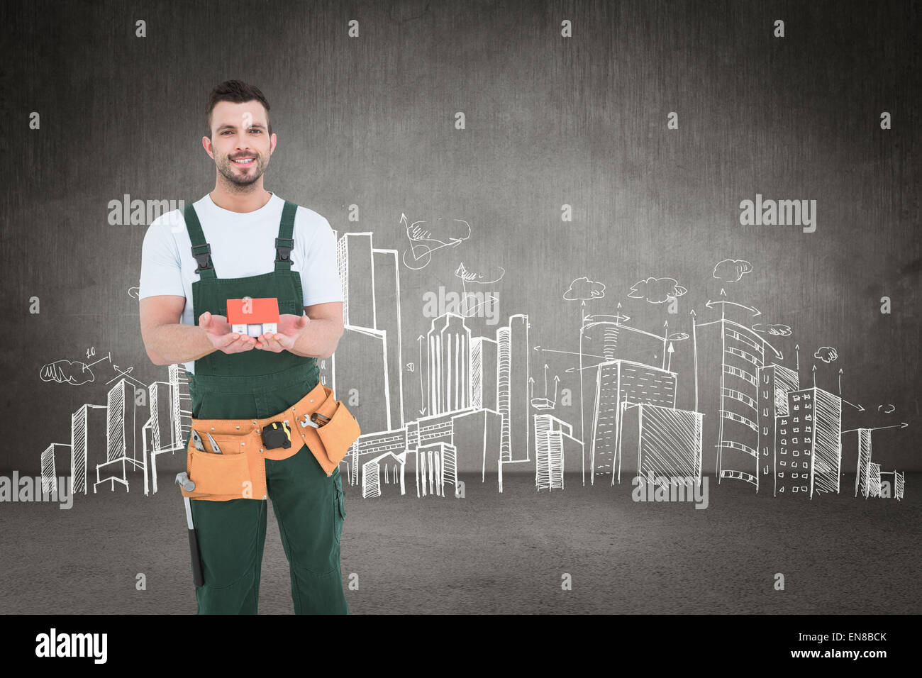 Composite image of happy construction worker holding house model Stock Photo
