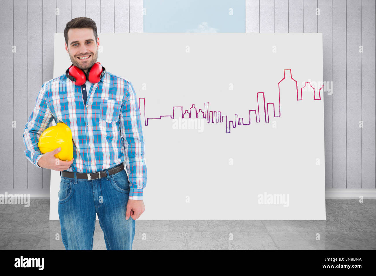 Composite image of confident manual worker with hardhat and ear muffs Stock Photo